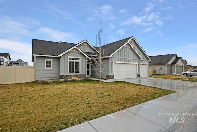 craftsman inspired home featuring fence, an attached garage, a front lawn, board and batten siding, and driveway