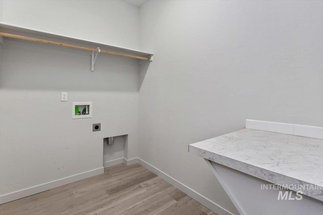 washroom with electric dryer hookup, laundry area, baseboards, light wood-style floors, and hookup for a washing machine
