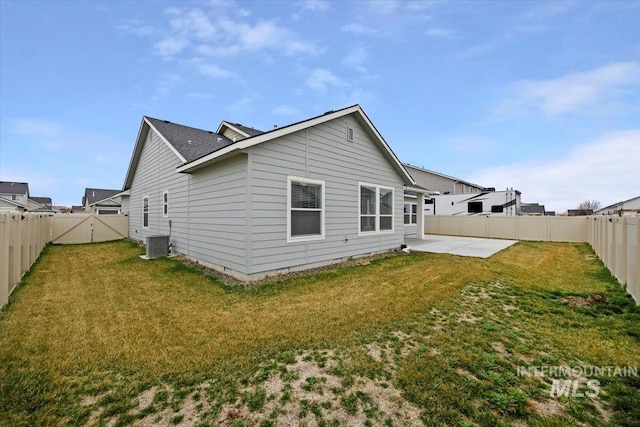 rear view of property with a patio area, a fenced backyard, crawl space, central AC, and a yard