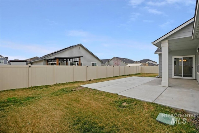 view of yard featuring fence and a patio area
