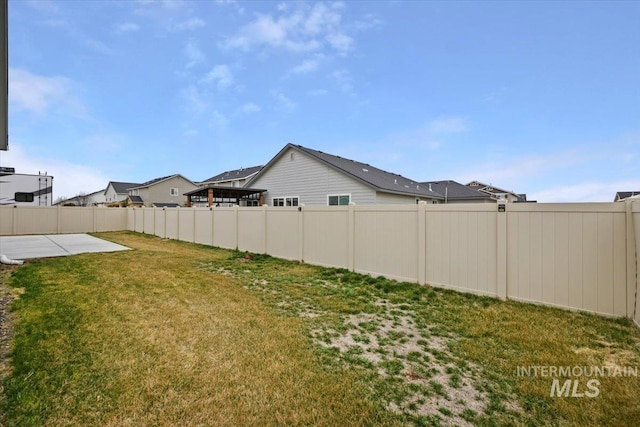 view of yard with a fenced backyard and a patio area