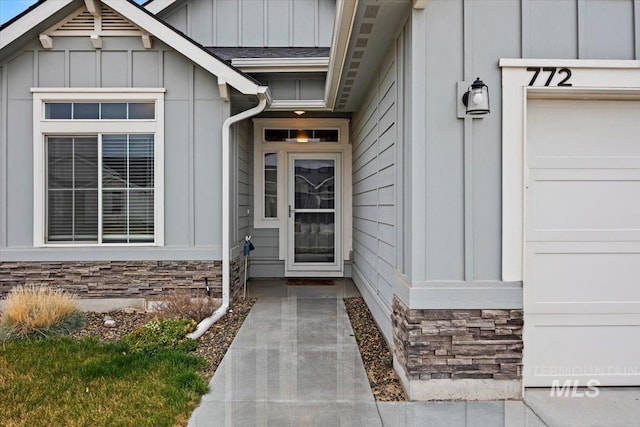 doorway to property with stone siding and board and batten siding