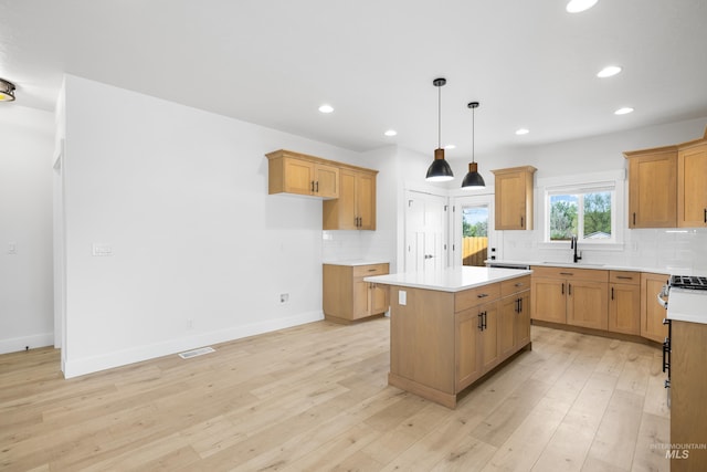 875 N 14th St, Payette, ID 83661 - kitchen featuring a sink, a center island, tasteful backsplash, light countertops, and recessed lighting