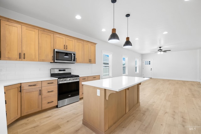 875 N 14th St, Payette, ID 83661 - kitchen featuring appliances with stainless steel finishes, tasteful backsplash, a center island, light countertops, and recessed lighting