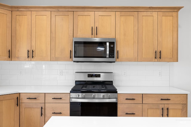875 N 14th St, Payette, ID 83661 - kitchen featuring appliances with stainless steel finishes, light countertops, and decorative backsplash