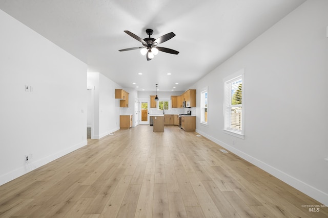 875 N 14th St, Payette, ID 83661 - unfurnished living room featuring a ceiling fan, baseboards, light wood-type flooring, and recessed lighting