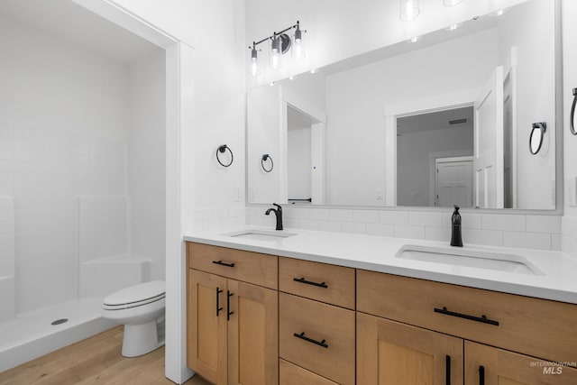 875 N 14th St, Payette, ID 83661 - full bathroom with toilet, double vanity, wood finished floors, and a stall shower
