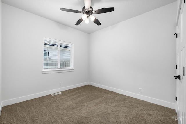 875 N 14th St, Payette, ID 83661 - empty room featuring dark carpet, baseboards, and a ceiling fan