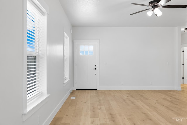 875 N 14th St, Payette, ID 83661 - foyer with light wood finished floors, ceiling fan, and baseboards