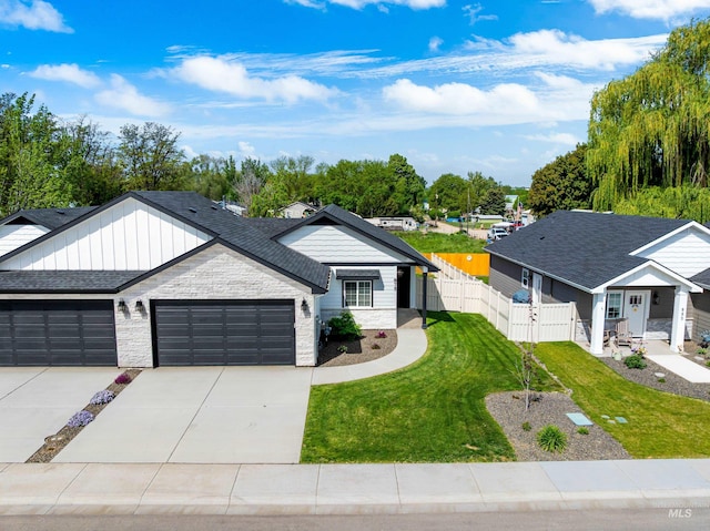 875 N 14th St, Payette, ID 83661 - view of front of property featuring an attached garage, driveway, stone siding, and roof with shingles