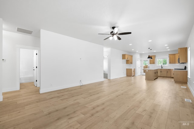 875 N 14th St, Payette, ID 83661 - unfurnished living room featuring a ceiling fan, light wood-style flooring, recessed lighting, and baseboards