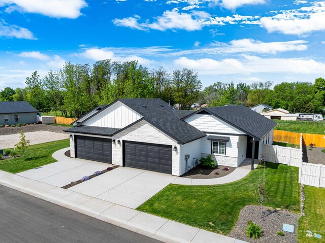 875 N 14th St, Payette, ID 83661 - single story home with an attached garage, concrete driveway, roof with shingles, and brick siding