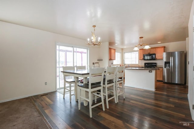 2059 Spring Creek Dr, Fruitland, ID 83619 - dining area featuring a chandelier, recessed lighting, baseboards, and dark wood finished floors