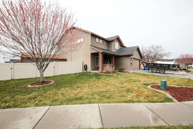 2059 Spring Creek Dr, Fruitland, ID 83619 - view of front of house with a garage, a front yard, driveway, and fence