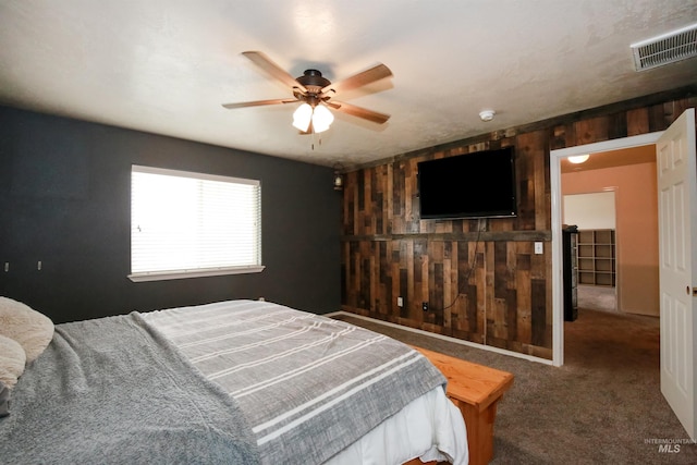 2059 Spring Creek Dr, Fruitland, ID 83619 - carpeted bedroom with wooden walls, visible vents, and ceiling fan