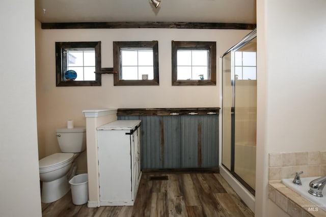 2059 Spring Creek Dr, Fruitland, ID 83619 - bathroom with toilet, a bath, a stall shower, and wood finished floors