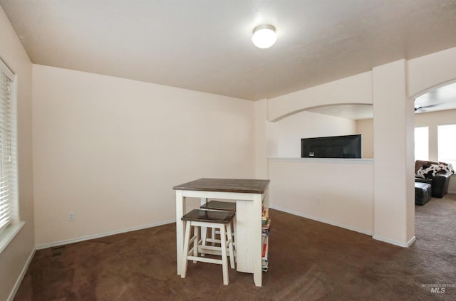 2059 Spring Creek Dr, Fruitland, ID 83619 - dining area featuring dark carpet, baseboards, and a ceiling fan