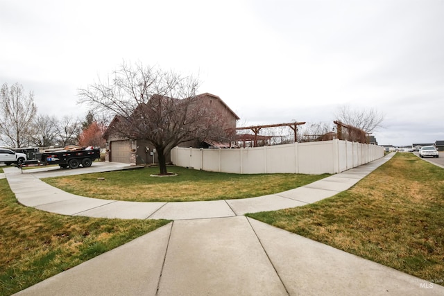 2059 Spring Creek Dr, Fruitland, ID 83619 - view of yard with fence, a garage, and concrete driveway