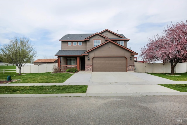 2059 Spring Creek Dr, Fruitland, ID 83619 - view of front of house with a garage, fence, a front lawn, brick siding, and concrete driveway