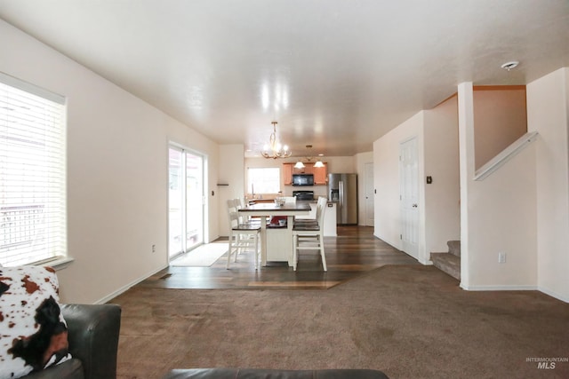 2059 Spring Creek Dr, Fruitland, ID 83619 - interior space featuring a chandelier, dark carpet, baseboards, and stairway