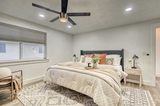 bedroom with ceiling fan and light hardwood / wood-style floors