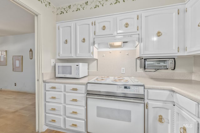 1245 SW 3rd Ave, Ontario, OR 97914 - kitchen featuring white appliances, light countertops, white cabinetry, under cabinet range hood, and light wood-style floors