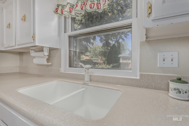 1245 SW 3rd Ave, Ontario, OR 97914 - kitchen view of a sink, white cabinetry, and light countertops