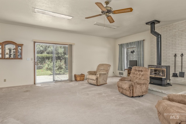 1245 SW 3rd Ave, Ontario, OR 97914 - living area featuring a wood stove, carpet flooring, and ceiling fan