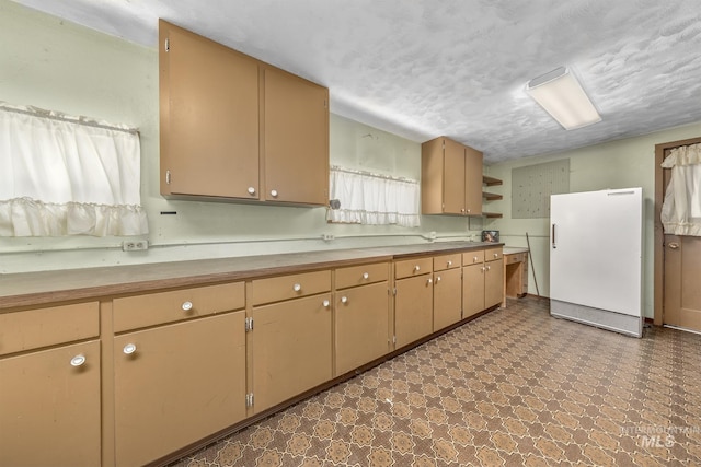 1245 SW 3rd Ave, Ontario, OR 97914 - kitchen featuring freestanding refrigerator, dark floors, and light countertops