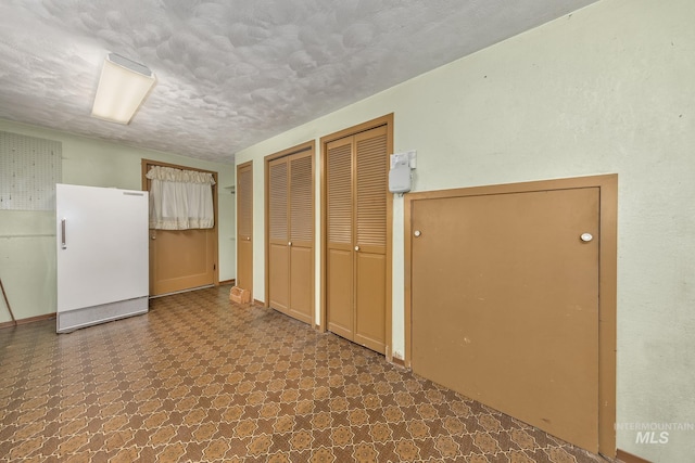 1245 SW 3rd Ave, Ontario, OR 97914 - unfurnished bedroom with two closets, freestanding refrigerator, and tile patterned floors