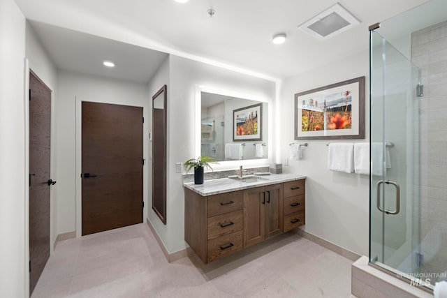 bathroom featuring vanity, walk in shower, and tile patterned flooring