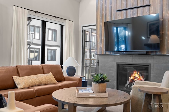 living room with a tile fireplace