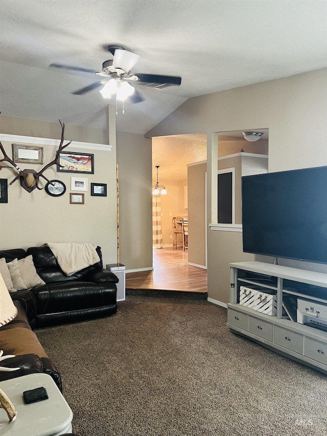 living area with carpet, a ceiling fan, and lofted ceiling