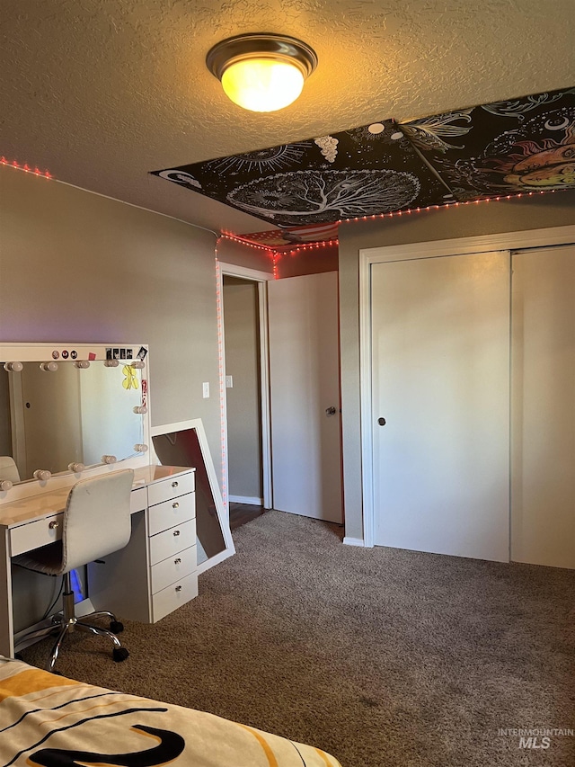 unfurnished bedroom featuring a textured ceiling, carpet floors, and an office area