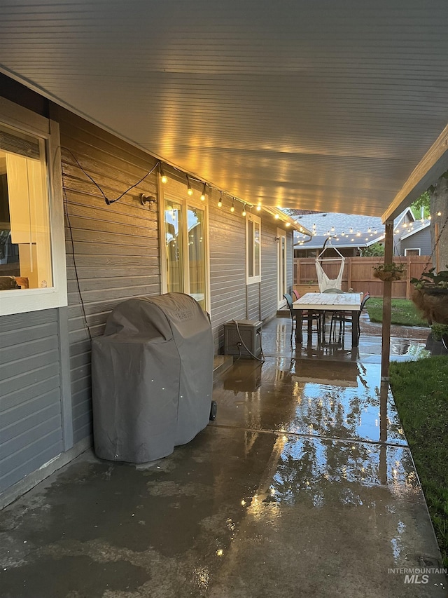 view of patio / terrace featuring fence and a grill