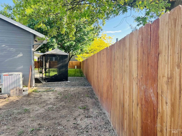 fenced backyard with cooling unit