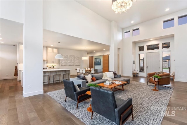 1891 E Golden Oak Ct, Meridian, ID 83646 - living room with a high ceiling, a chandelier, dark wood-style floors, recessed lighting, and baseboards