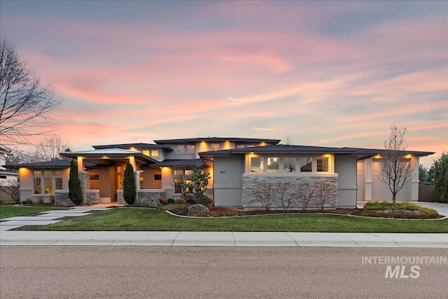 1891 E Golden Oak Ct, Meridian, ID 83646 - prairie-style home with stone siding, concrete driveway, a yard, and stucco siding