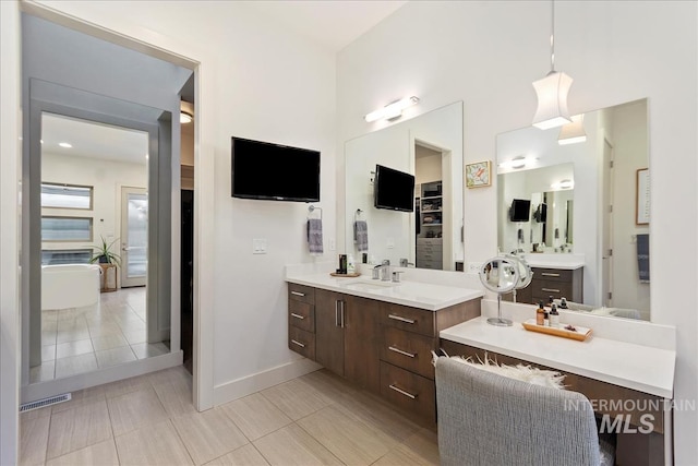 1891 E Golden Oak Ct, Meridian, ID 83646 - bathroom with vanity, baseboards, a bathtub, and tile patterned flooring