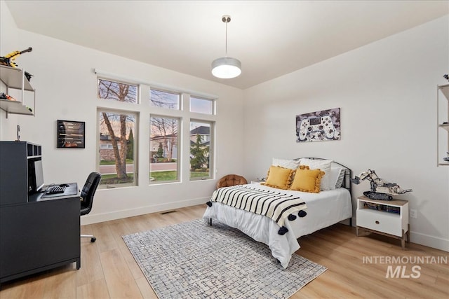 1891 E Golden Oak Ct, Meridian, ID 83646 - bedroom with light wood-type flooring, baseboards, and an office area
