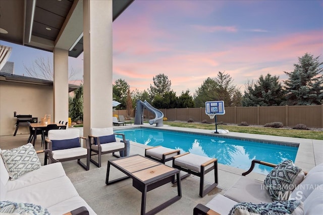 1891 E Golden Oak Ct, Meridian, ID 83646 - view of swimming pool featuring a water slide, outdoor lounge area, a fenced backyard, and a patio