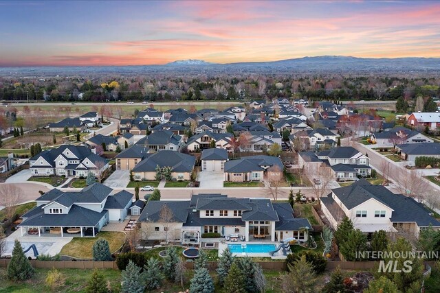1891 E Golden Oak Ct, Meridian, ID 83646 - aerial view at dusk of a mountain view, a residential view, and view of pool