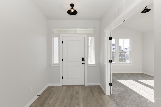 foyer with visible vents, light wood finished floors, and baseboards