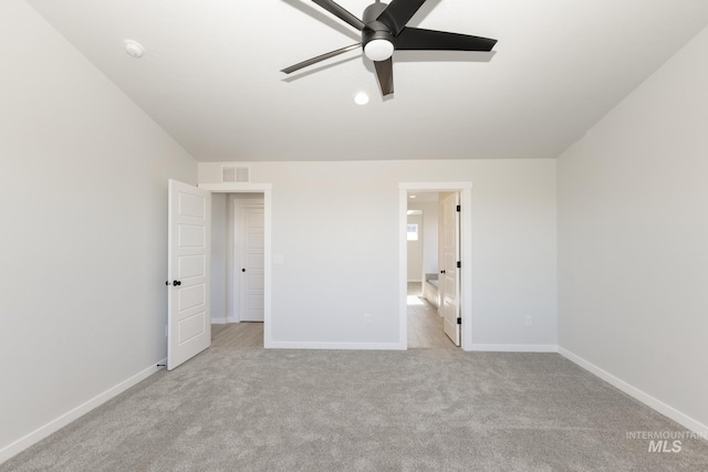 unfurnished bedroom with a ceiling fan, carpet, visible vents, and baseboards