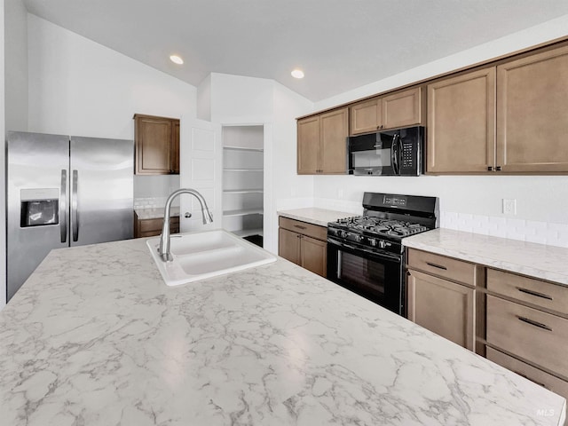 5394 N Elmstone Ave, Meridian, ID 83646 - kitchen with black appliances, a sink, lofted ceiling, light stone counters, and recessed lighting