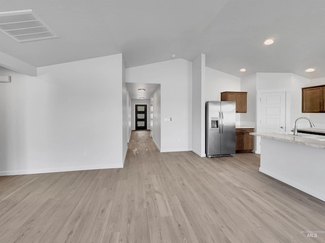 5394 N Elmstone Ave, Meridian, ID 83646 - kitchen featuring stainless steel refrigerator with ice dispenser, light wood-style flooring, a sink, baseboards, and recessed lighting