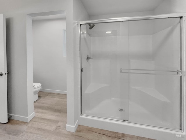5394 N Elmstone Ave, Meridian, ID 83646 - bathroom with baseboards, wood finished floors, a shower stall, and toilet
