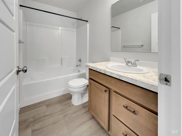 5394 N Elmstone Ave, Meridian, ID 83646 - bathroom with toilet, vanity, wood finished floors, and tub / shower combination