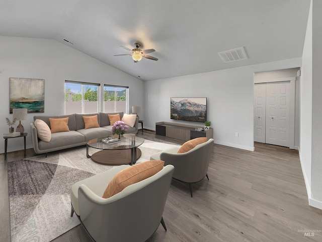 5394 N Elmstone Ave, Meridian, ID 83646 - living area featuring lofted ceiling, ceiling fan, wood finished floors, and baseboards