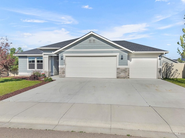 5394 N Elmstone Ave, Meridian, ID 83646 - ranch-style home with an attached garage, stone siding, driveway, and a shingled roof